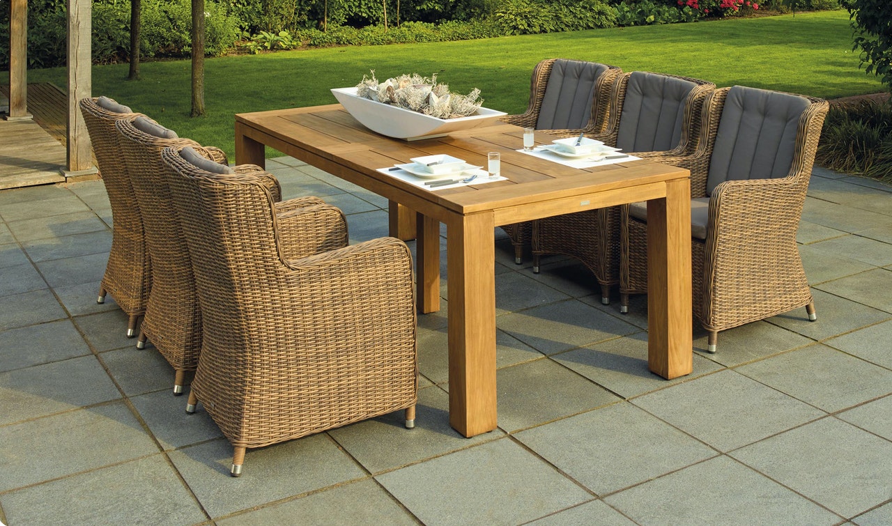 Rattan garden furnitures placed in garden ready to be used by family and friends